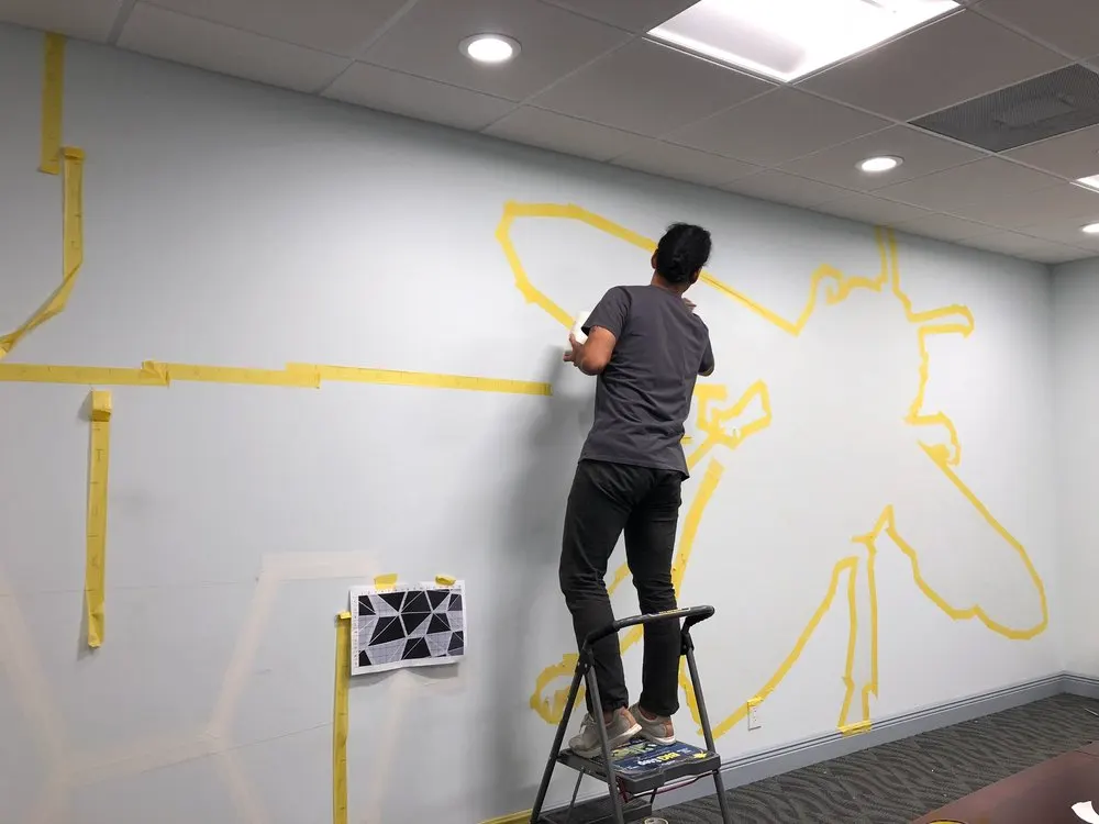 Jhonattan Arango taping off his design in the conference room at Bee Access Products in West Palm Beach.